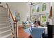Bright living room with high ceilings, large windows, a fireplace, and comfortable seating arrangements at 956 Kinghorn Nw Dr, Kennesaw, GA 30152