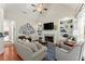 Cozy living room featuring a fireplace, built-in shelves, and vaulted ceilings at 956 Kinghorn Nw Dr, Kennesaw, GA 30152