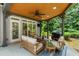 A cozy covered outdoor patio with wood ceiling, ceiling fan and comfortable seating at 956 Kinghorn Nw Dr, Kennesaw, GA 30152