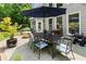Outdoor patio with a dining table and umbrella for comfortable outdoor living at 956 Kinghorn Nw Dr, Kennesaw, GA 30152
