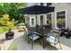Outdoor patio with dining table, seating, and a stylish umbrella for shade at 956 Kinghorn Nw Dr, Kennesaw, GA 30152