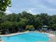 Large swimming pool area with lounge chairs, umbrellas, and plenty of space for relaxation at 956 Kinghorn Nw Dr, Kennesaw, GA 30152