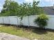 View of the backyard featuring a white fence, green grass, and mature trees at 2256 Hansford Pass, Buford, GA 30519