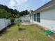 Landscaped backyard with green grass, white fencing, and a patio perfect for relaxing or entertaining at 2256 Hansford Pass, Buford, GA 30519