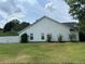 Spacious backyard with green grass and a white privacy fence, offering a serene outdoor space at 2256 Hansford Pass, Buford, GA 30519