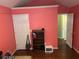 Bedroom with pink walls, overhead lighting and wood flooring at 2256 Hansford Pass, Buford, GA 30519