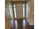 Welcoming hallway featuring a front door and wood floors at 2256 Hansford Pass, Buford, GA 30519