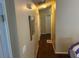 Long hallway with hardwood floors and neutral paint, connecting various rooms in the house at 2256 Hansford Pass, Buford, GA 30519