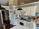 Bright kitchen featuring white cabinets, gas range, and white countertops at 2256 Hansford Pass, Buford, GA 30519