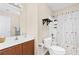 Neutral bathroom features a wood vanity, floral shower curtain and tile flooring at 3065 Moser Way, Marietta, GA 30060