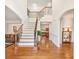 Bright foyer with hardwood floors, staircase with wrought iron railings, and high ceilings at 3065 Moser Way, Marietta, GA 30060