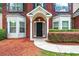 Inviting front entrance with a black door, white pillars, and manicured landscaping at 3065 Moser Way, Marietta, GA 30060