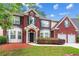 Charming two-story brick home featuring a well-manicured lawn and symmetrical design at 3065 Moser Way, Marietta, GA 30060