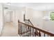 Upstairs hallway featuring hardwood floors, decorative railings, and a chandelier at 3065 Moser Way, Marietta, GA 30060