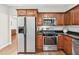 Functional kitchen featuring stainless steel appliances, wood cabinets, and granite counters at 3065 Moser Way, Marietta, GA 30060