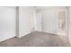 Neutral bedroom features closet, grey carpet, and entry to an ensuite bathroom at 3787 Stephanie Sw Dr, Atlanta, GA 30331