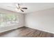Cozy bedroom filled with natural light from a bright window and plush wood floors at 3787 Stephanie Sw Dr, Atlanta, GA 30331
