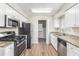 Efficient kitchen showcasing stainless steel appliances, granite countertops, and wood flooring at 3787 Stephanie Sw Dr, Atlanta, GA 30331