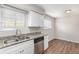 Efficient kitchen showcasing granite countertops, stainless steel appliances, and wood flooring at 3787 Stephanie Sw Dr, Atlanta, GA 30331