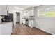 Well-lit kitchen featuring modern appliances, granite countertops and wood flooring at 3787 Stephanie Sw Dr, Atlanta, GA 30331