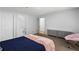 Carpeted bedroom provides a serene atmosphere and natural light, complemented by ample closet space at 4203 Fairington Village Dr, Lithonia, GA 30038