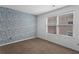 Bedroom featuring patterned accent wall and natural light at 4203 Fairington Village Dr, Lithonia, GA 30038