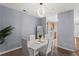Well-lit dining room features a modern light fixture and opens to the kitchen at 4203 Fairington Village Dr, Lithonia, GA 30038