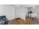 Open-concept entryway with hardwood flooring and a dining space with a modern table set at 4203 Fairington Village Dr, Lithonia, GA 30038