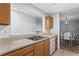 Kitchen view to dining room featuring a double sink and white dishwasher at 4203 Fairington Village Dr, Lithonia, GA 30038