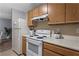 Kitchen featuring wooden cabinets and white appliances at 4203 Fairington Village Dr, Lithonia, GA 30038