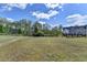 Expansive backyard with lush green grass and views of neighboring houses and trees beyond the grass at 4349 Northmark Ln, Buford, GA 30518