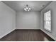 Empty dining area with dark hardwood flooring, a chandelier, and a view out the window at 4349 Northmark Ln, Buford, GA 30518