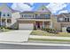 Charming two-story brick home featuring a well-manicured lawn, two car garage, and inviting front porch at 4349 Northmark Ln, Buford, GA 30518