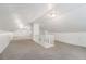 Bright attic area with carpeting, a railing, and plenty of space at 1932 Neely Ave, Atlanta, GA 30344