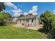 Spacious backyard with lawn and partial home view and side driveway at 1932 Neely Ave, Atlanta, GA 30344
