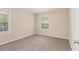 Cozy bedroom with neutral carpet, trim, and two windows for natural light at 1932 Neely Ave, Atlanta, GA 30344