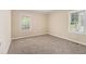 Neutral bedroom with carpet, baseboard trim, and two windows at 1932 Neely Ave, Atlanta, GA 30344