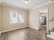 A dining room with a staircase, hardwood floors, and view of the kitchen at 1932 Neely Ave, Atlanta, GA 30344