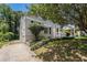 A house on a lot with manicured lawn, side view, and a bright red front door at 1932 Neely Ave, Atlanta, GA 30344