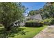 Charming home with a well-maintained lawn and lush greenery, and a bright red front door at 1932 Neely Ave, Atlanta, GA 30344