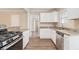 Well-lit kitchen features stainless steel appliances, granite countertops, and white cabinets at 1932 Neely Ave, Atlanta, GA 30344