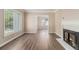 Living room featuring new hardwood floors, a fireplace, and natural light from a large window at 1932 Neely Ave, Atlanta, GA 30344