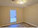 This bedroom features neutral walls, wood flooring, a modern ceiling light, and a bright window with blinds at 508 Jaywood Dr, Stone Mountain, GA 30083