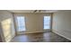 This bedroom features hardwood floors, two windows with blinds, and a ceiling fan with overhead lighting at 508 Jaywood Dr, Stone Mountain, GA 30083