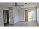 Bedroom featuring ceiling fan, wood-look floors, and bathroom access at 508 Jaywood Dr, Stone Mountain, GA 30083