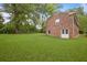 Large backyard featuring lush grass and a classic brick home exterior at 59 Oakmont Nw Dr, Marietta, GA 30064