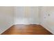 Bedroom with hardwood floors, natural light, and a closet with louvered doors at 59 Oakmont Nw Dr, Marietta, GA 30064