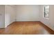Bright bedroom features hardwood floors, closet with white bi-fold doors, and natural light through a window at 59 Oakmont Nw Dr, Marietta, GA 30064