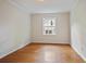 Neutral-toned bedroom features hardwood floors and a window providing natural light at 59 Oakmont Nw Dr, Marietta, GA 30064