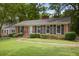 Brick house with manicured lawn and brick walkway to front door, black shutters adorn windows at 59 Oakmont Nw Dr, Marietta, GA 30064